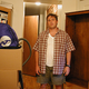 Derek Olson stands among some of the boxes he'd hoped to unpack last week.